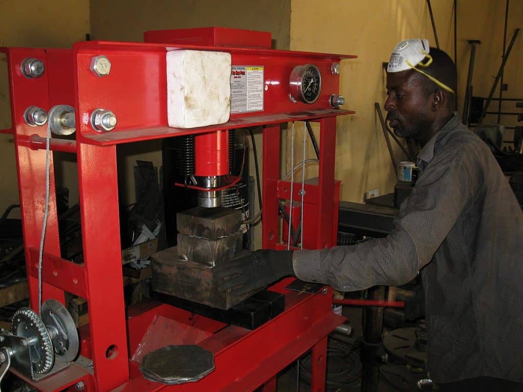 Man using industrial hydraulic press